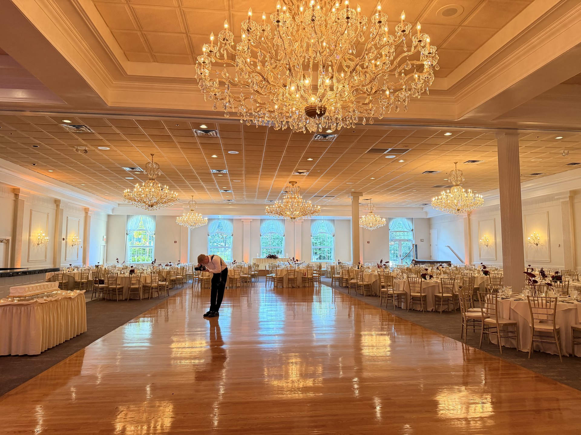 Grand ballroom reception with warm uplighting — One Idea Entertainment