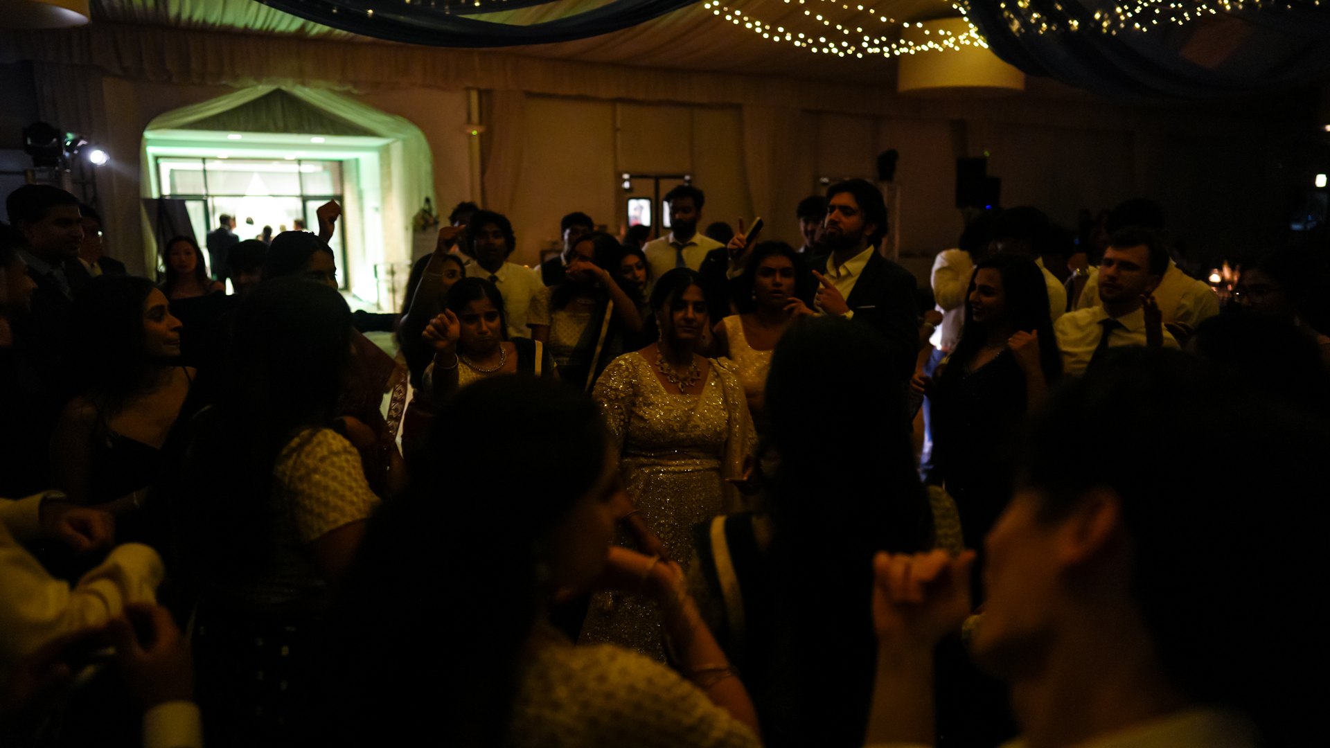 Guests on a packed dance floor with concert-style lighting — One Idea Entertainment