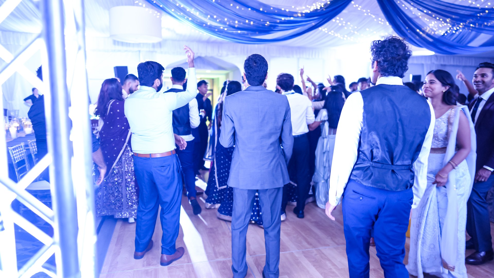 Guests on a packed dance floor with concert-style lighting — One Idea Entertainment